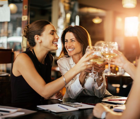 Two women toasting with wine