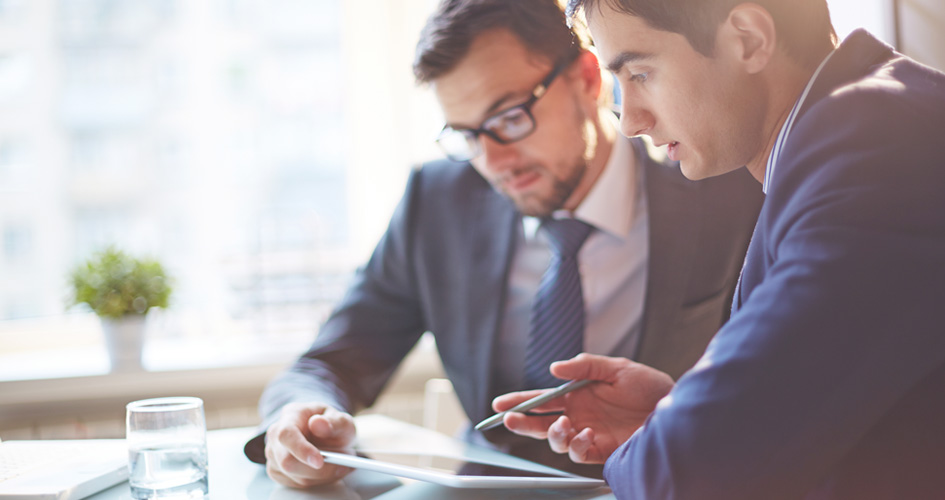 Men reviewing business report