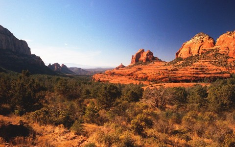 view of the red rock mountains from a grassy plain
