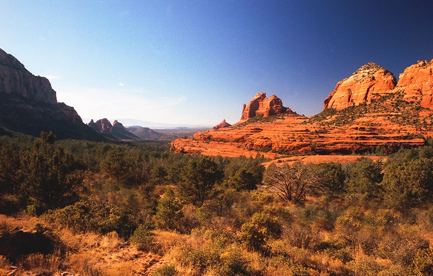 view of the red rock mountains from a grassy plain