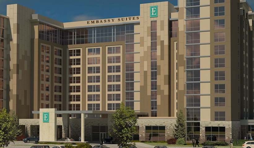 Rendering of the exterior of an Embassy Suites hotel and parking lot in Denton, TX