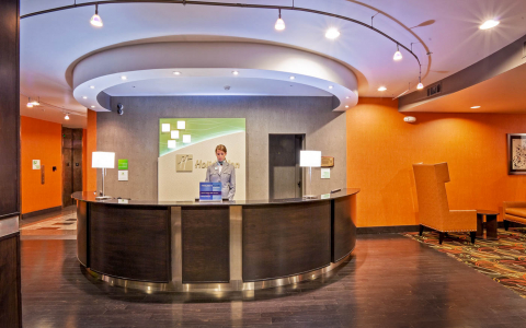 Woman standing behind the front desk at a Holiday Inn hotel