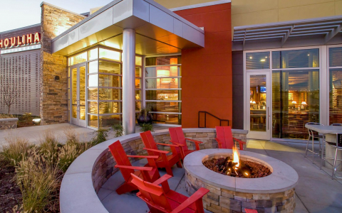 Houlihans Restaurant exterior with fire pit and chairs in front