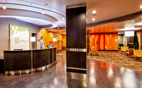 Holiday Inn hotel lobby with a woman at the front desk