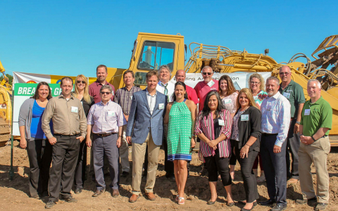 Team posing at construction site
