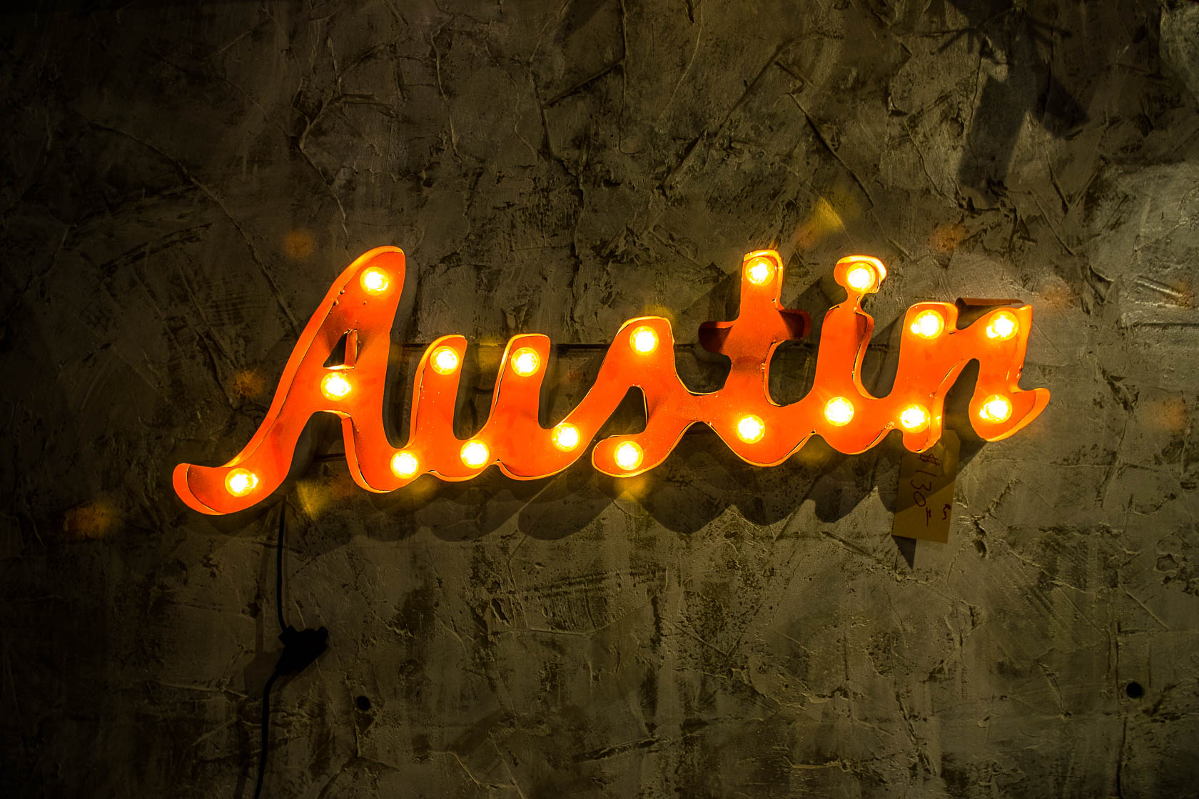 Austin logo in orange and yellow accents
