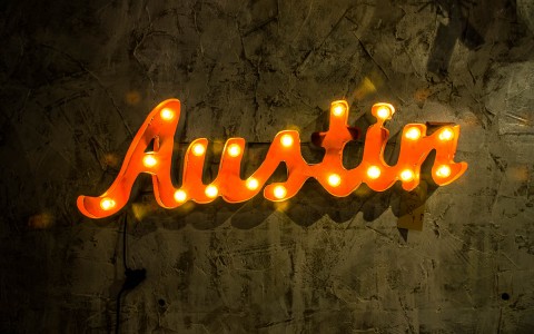 Austin logo in orange and yellow accents