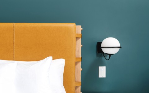 closeup view of a bed and a small nightstand Origin Hotel Austin 