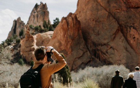 guy taking picture of scenic view on his hike