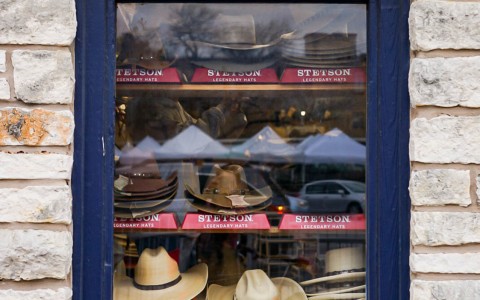 window with many different types of hats
