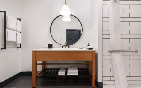 bathroom with vanity and roll in shower
