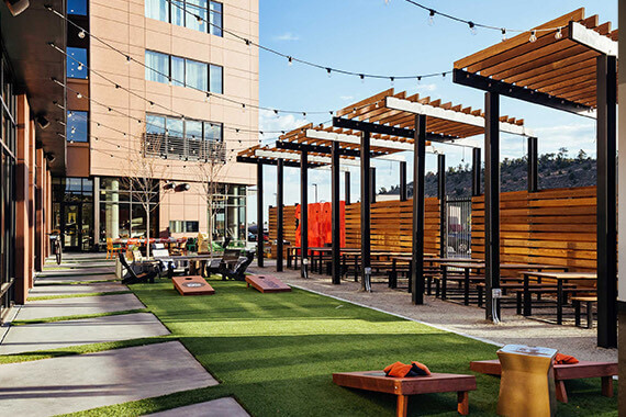 beer garden with plenty of shaded cabanas and corn hole
