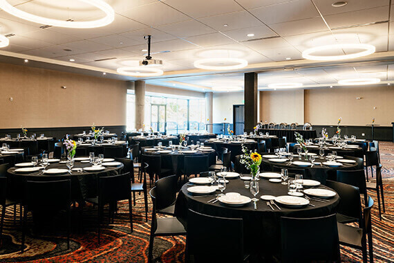 event space with round tables covered with black cloths