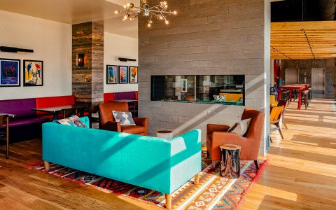 multicolored couches surrounding the lobby fireplace