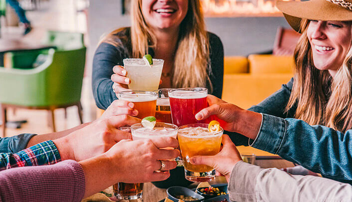 group fo gals toasting with margaritas