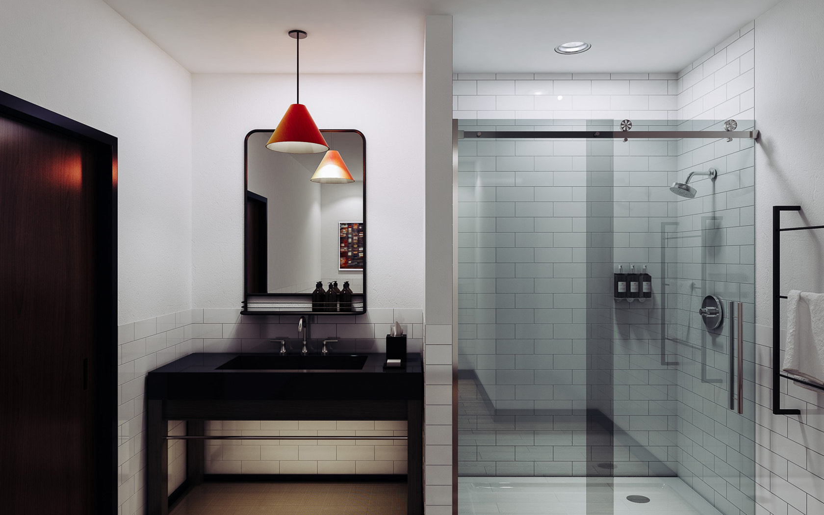 hotel bathroom with walk in glass shower and dark vanity sink