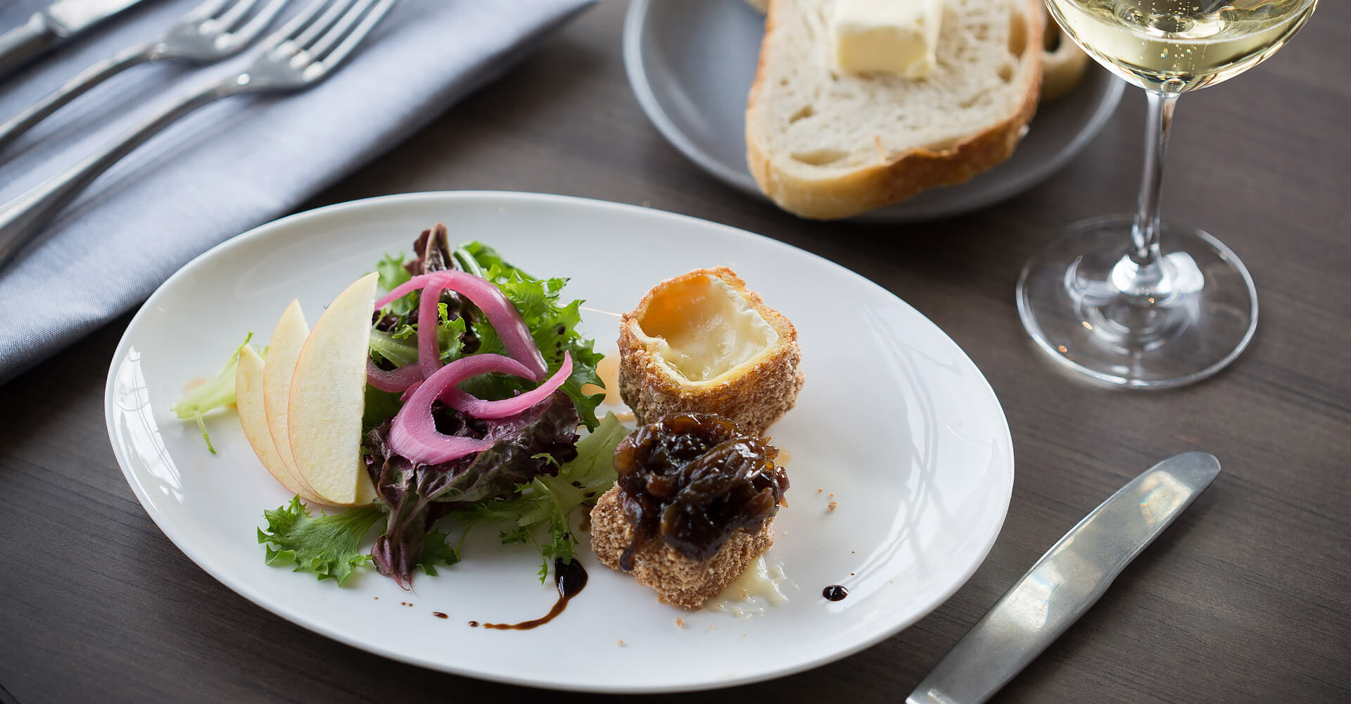 plate with some puff pastry stuffed with cheese and a side salad