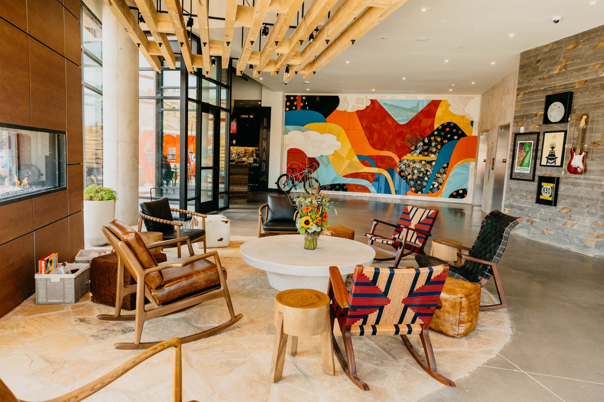 colorful lounge area with a circular table and tribal patterned chairs surrounding it