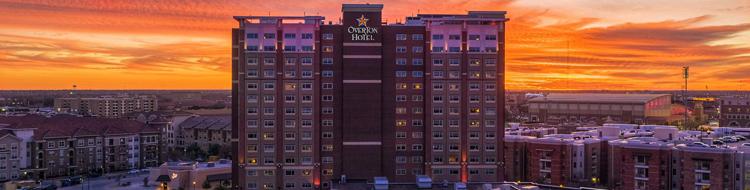 exterior view of the hotel facade with a beautiful sunset