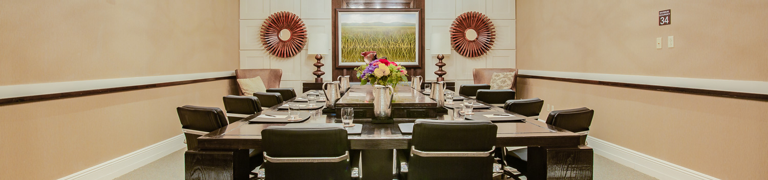 conference room with large tables and chairs and decor hangin on walls