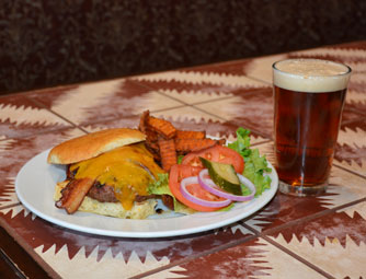 bacon cheeseburger and glass of beer