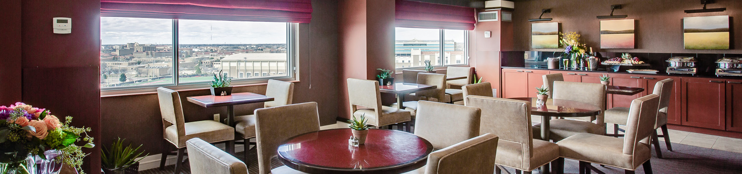 breakfast dining area with tables with brown chairs and a view of texas tech university