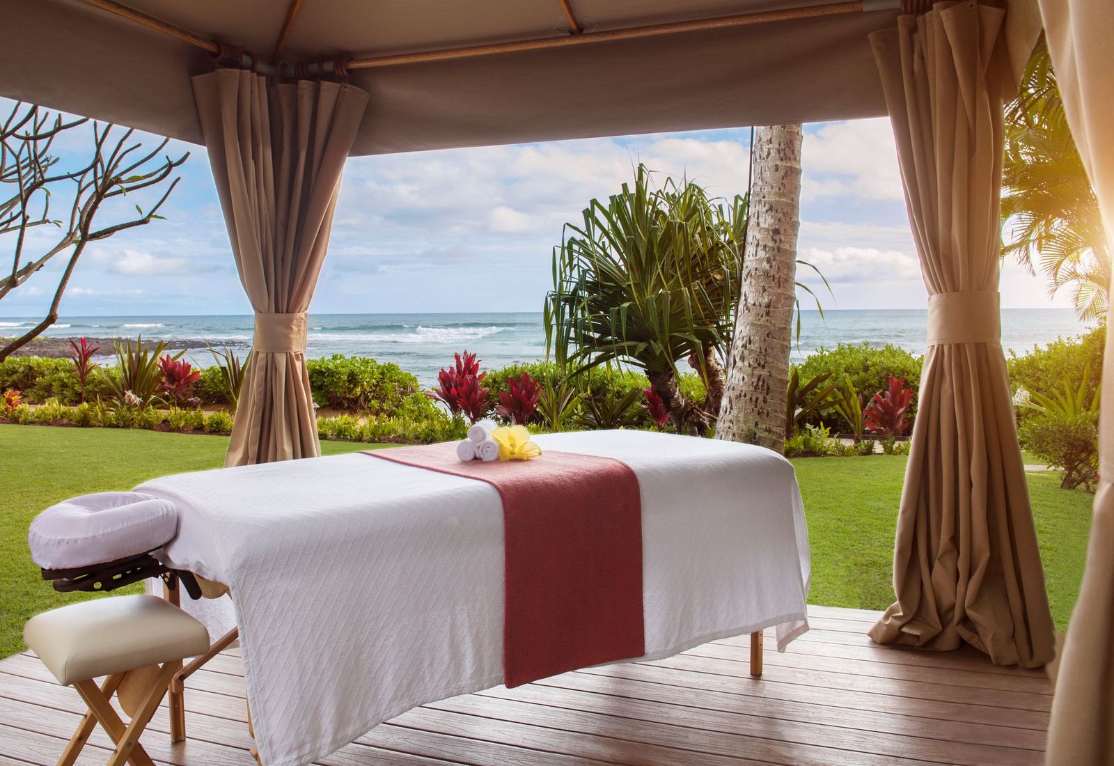 Spa outdoor zone with feature as a massage bed 3 towels and a chair with the beach vibes 