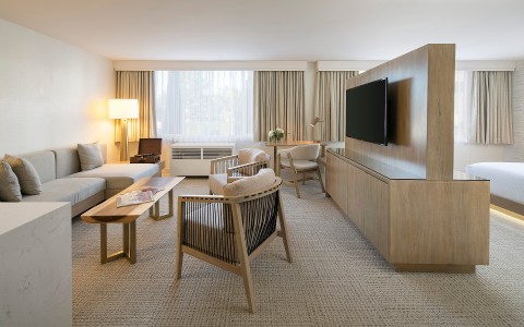 hotel room with beige furniture and TV