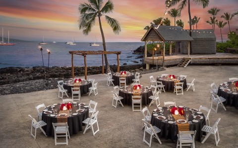 tables set up on the beach for a party