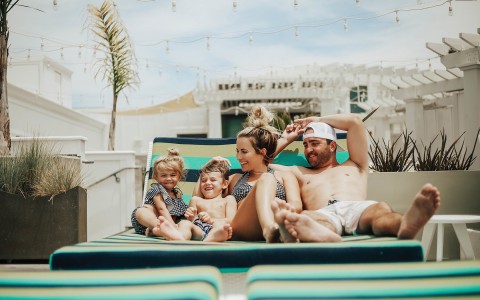 a family sitting by the pool