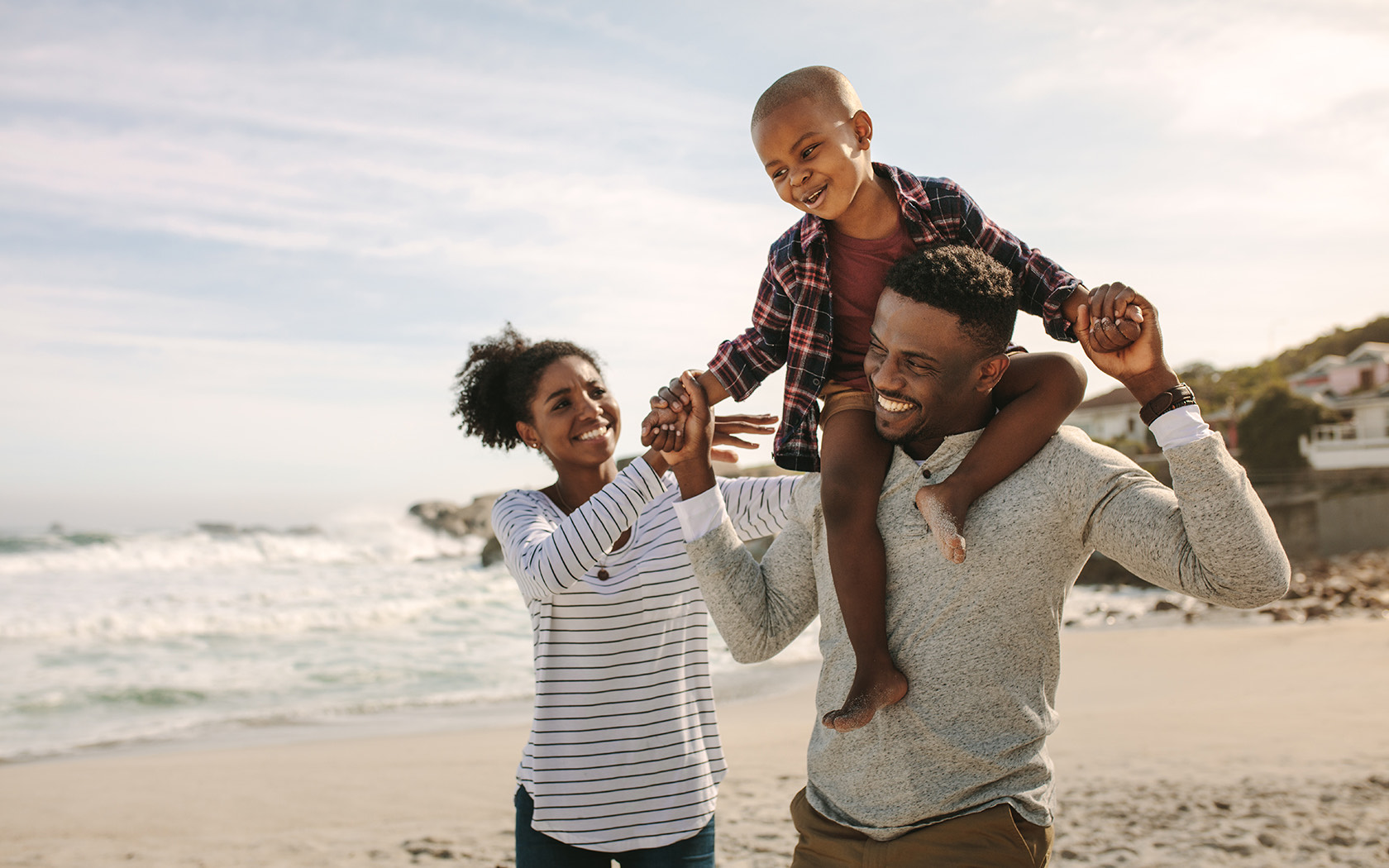 Family having fun by the beach with small boy