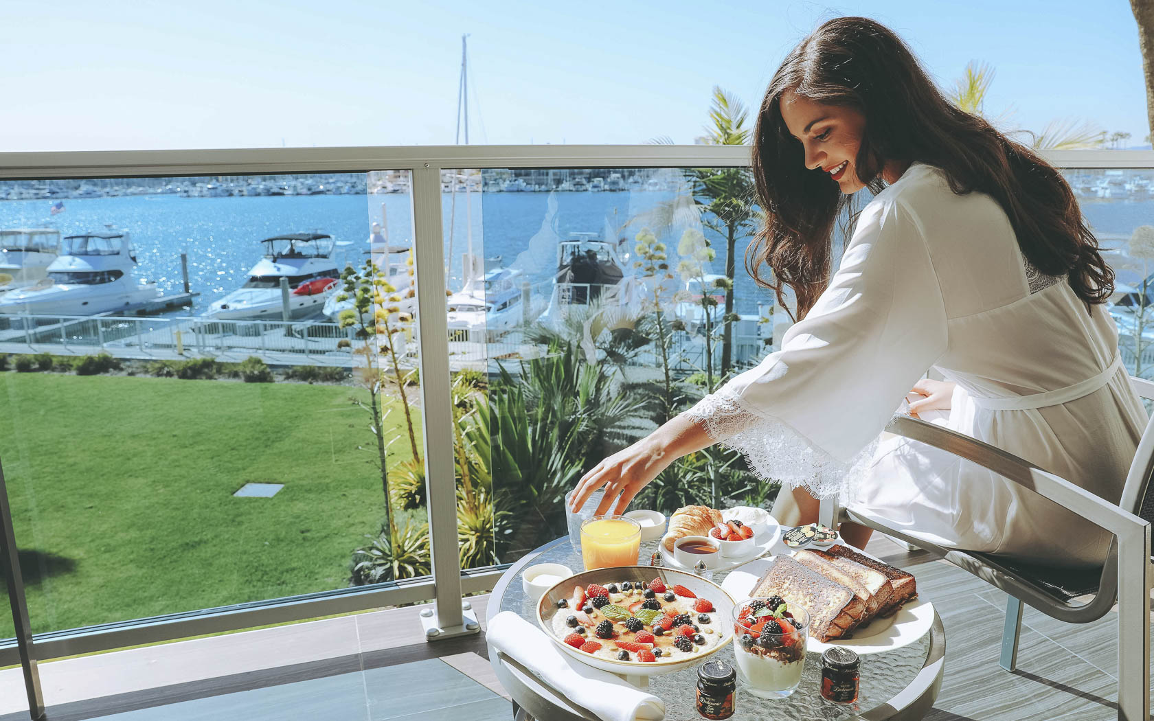 Woman enjoying breakfast with the marina views