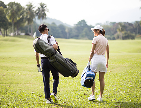 couple walking on a golf course