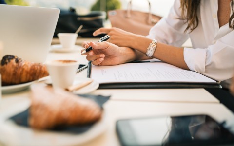 two women taking notes during a meeting