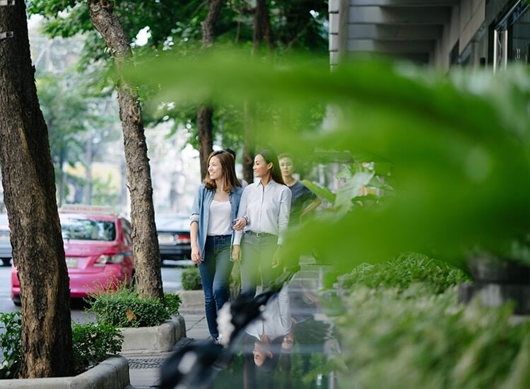 two women walking down the street in the city