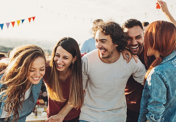 Group of friends gathered laughing outside