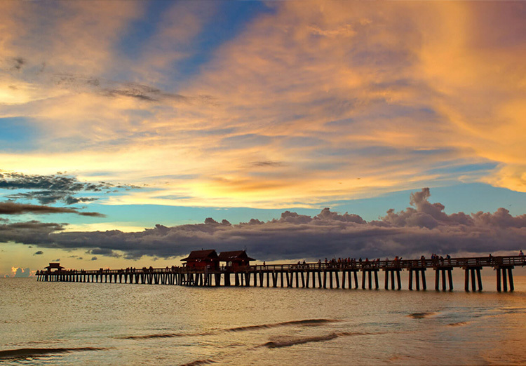 Sun rise on the beach with pier in the back