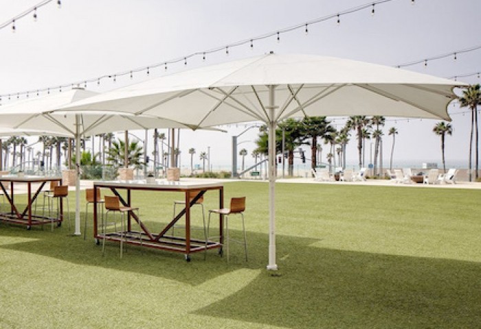 tables on the exterior with parasols and fairly lights