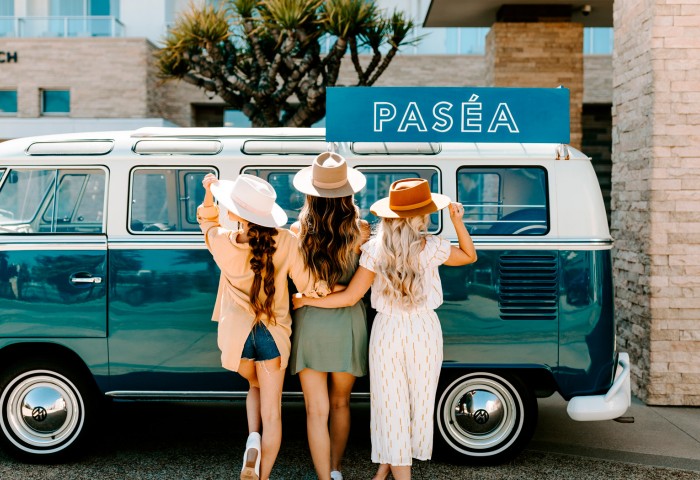 three women posing in front of the pasea van 