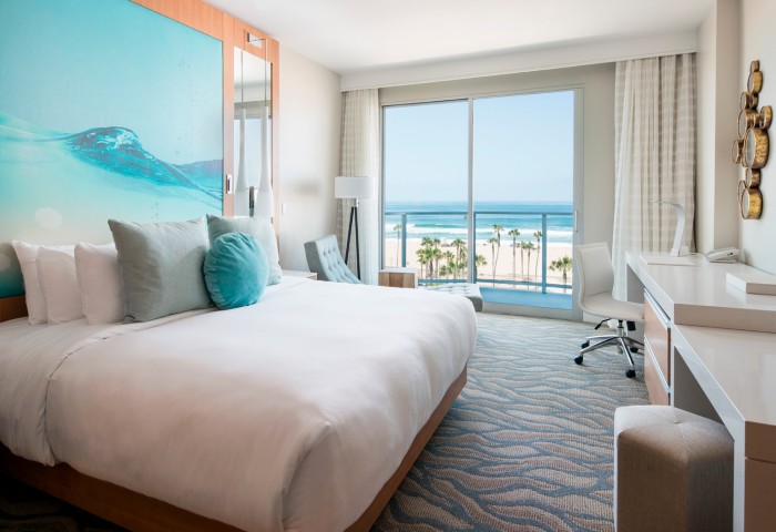 guest room with a bed and ocean view 