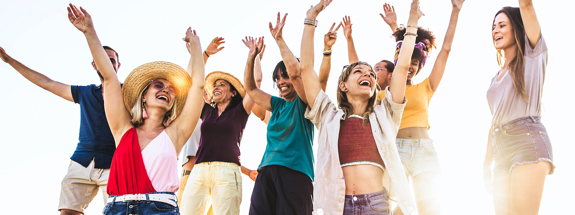 people with their arms up celebrating