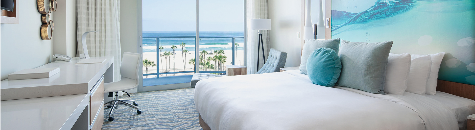 hotel room with bed and cushions