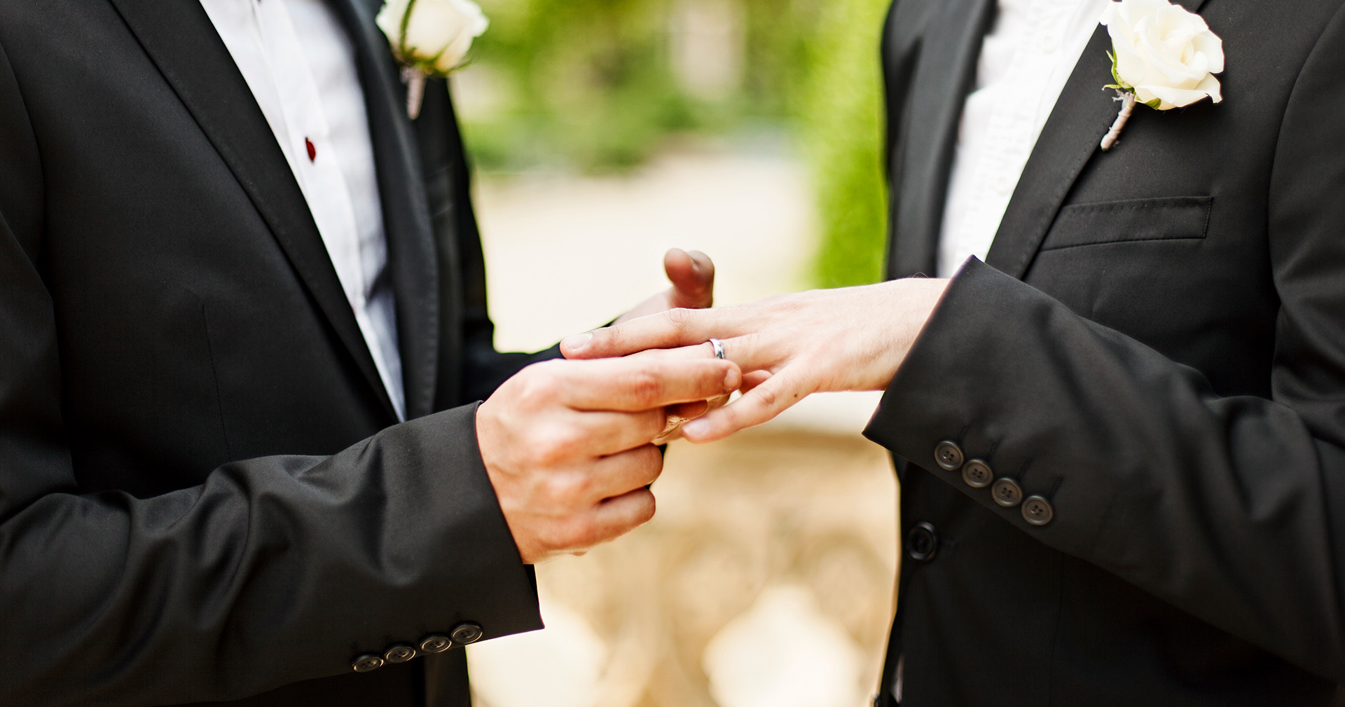 man putting a finger on his male partner