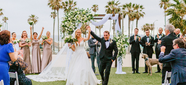 newly married couple walking with their hands together