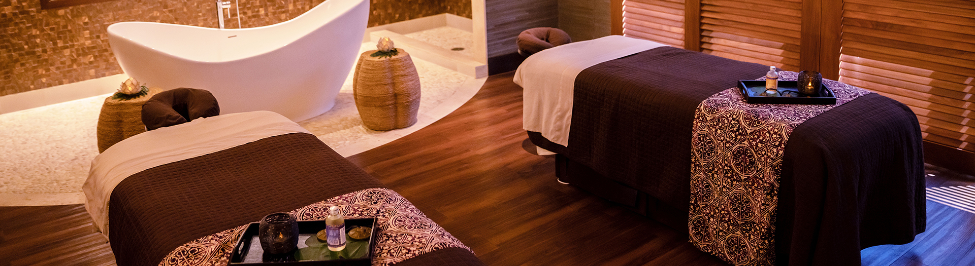 spa room set up with a bathtub and spa beds