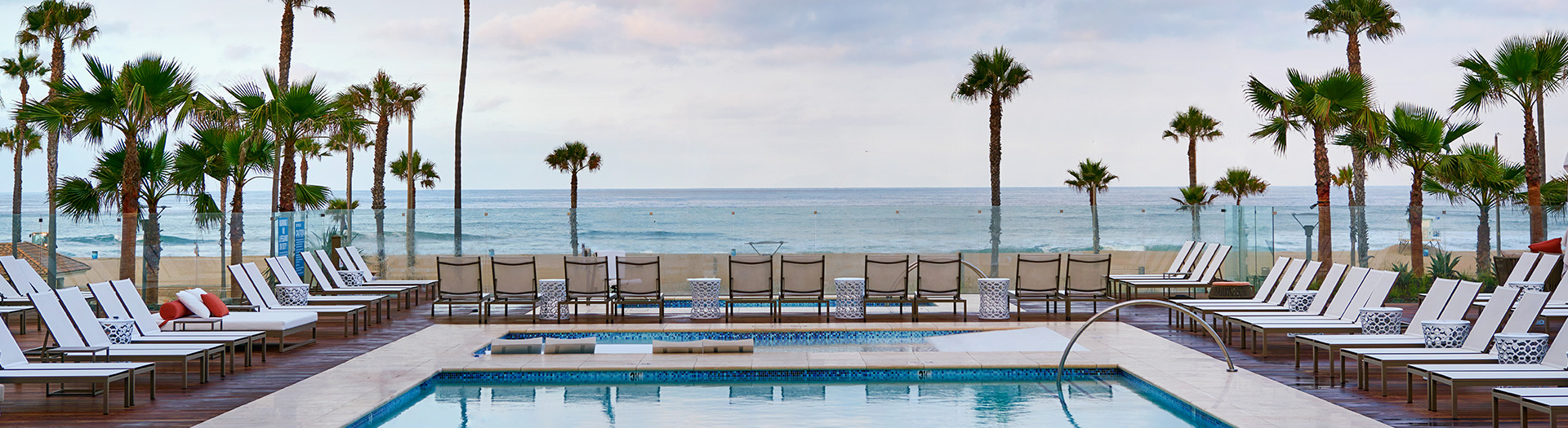 pool with sun beds and view to the ocean