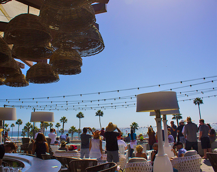 People gathered on a patio with string lights