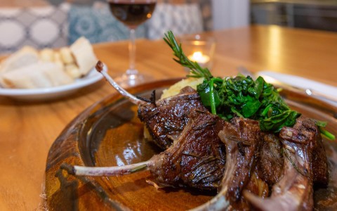 close up view of gourmet plated dish with steak served on the bone