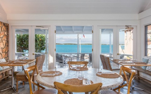 view of indoor dining area with view outside to ocean