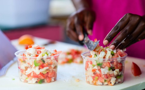 man cutting up ingredients to create ceviche